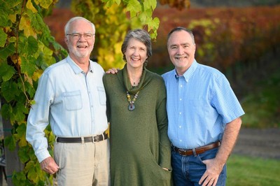 Earl, Hilda, and Greg Jones with vineyard in background.