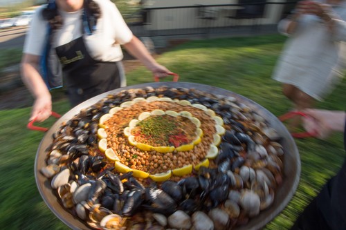 Large paella being walked out to guess by two Abacela staffers.