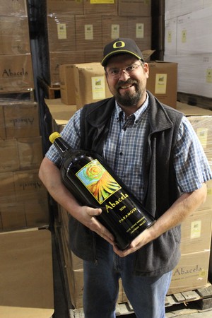 Andrew Wenzl winemaker holding a huge wine bottle of Paramour