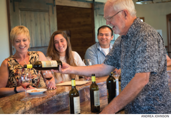 Earl pouring wine in the tasting room to guests