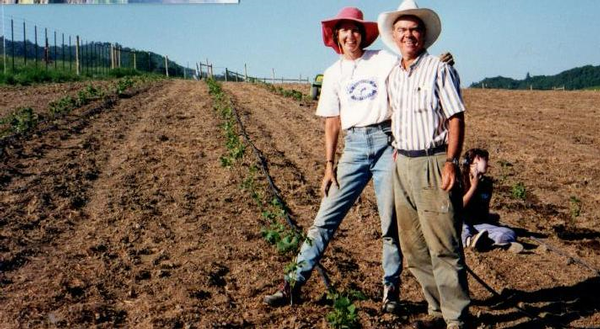 Hilda and Earl planting in the vineyard